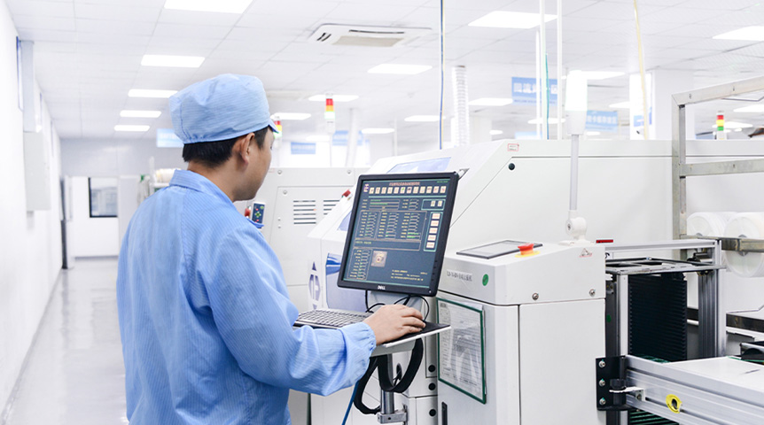 Operator monitoring an SMT production machine